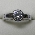Solitaire bezel set round brilliant cut diamond engagement ring