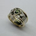Lustrous contemporary style green sapphire and diamond dress ring
