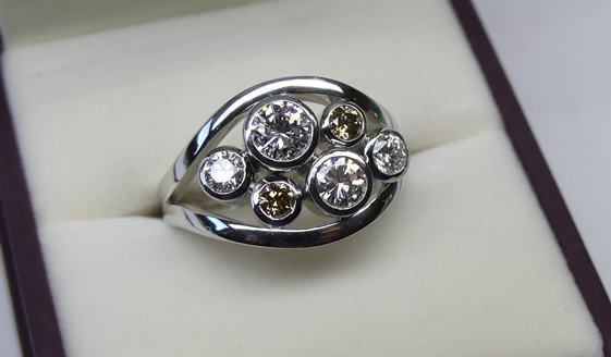 Platinum contemporary design white and champagne diamond ring