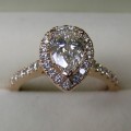Pear shaped diamond rose gold halo engagement ring