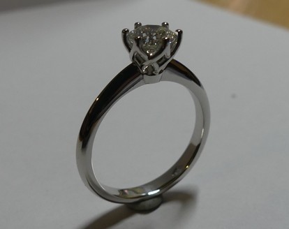 Platinum claw set solitaire diamond engagement ring