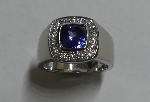 Cushion cut tanzanite and diamond engagement ring