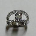 Contemporary style oval diamond dress ring with diamond set split band