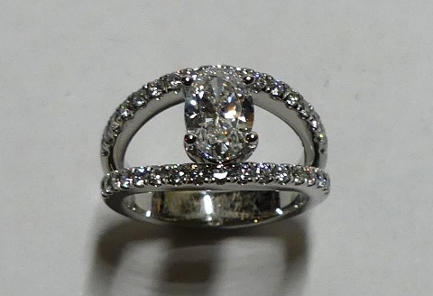 Contemporary style oval diamond dress ring with diamond set split band
